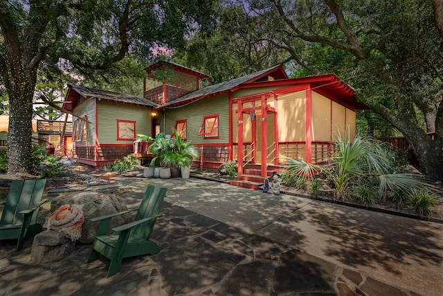 back of house with a patio area and a deck