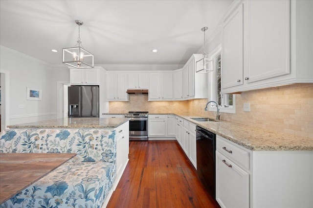 kitchen featuring under cabinet range hood, stainless steel appliances, a sink, white cabinets, and backsplash