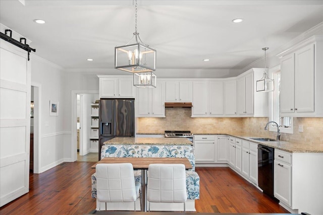 kitchen with black dishwasher, a barn door, white cabinets, refrigerator with ice dispenser, and a sink