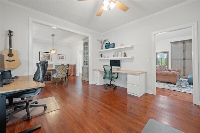 office with wood finished floors, built in study area, and crown molding