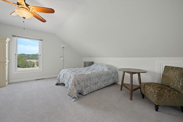 carpeted bedroom featuring a ceiling fan, lofted ceiling, visible vents, and baseboards