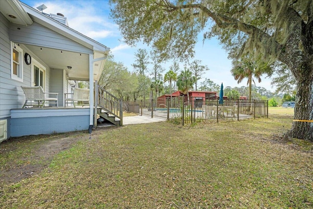 view of yard featuring a fenced in pool and fence