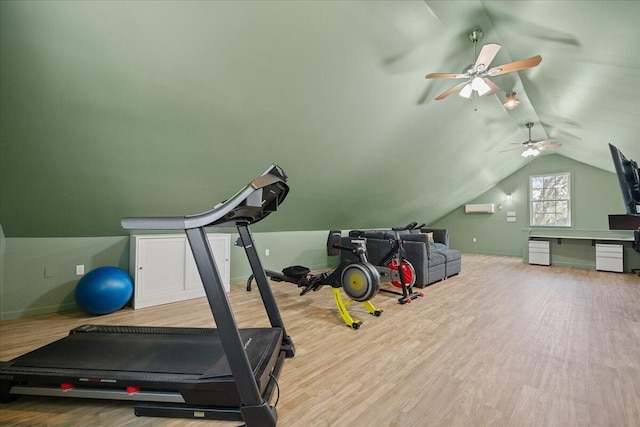 exercise room featuring lofted ceiling, baseboards, and wood finished floors