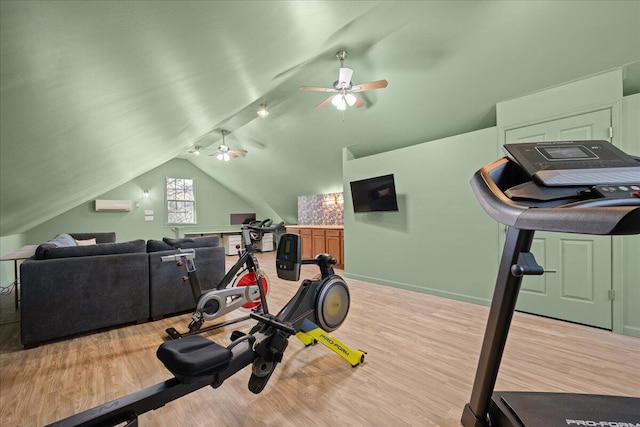 workout room with lofted ceiling, an AC wall unit, ceiling fan, and wood finished floors