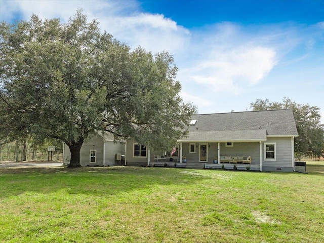 back of house with crawl space, a lawn, and central air condition unit