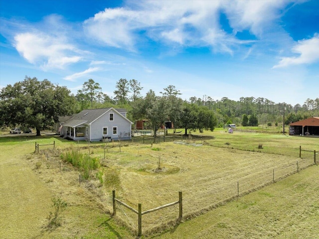 view of yard featuring a rural view and fence