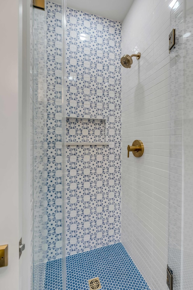 bathroom with a shower with shower door