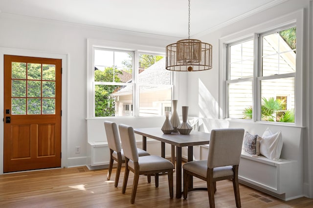 517 Royall Ave, Mount Pleasant, SC 29464 - dining room featuring ornamental molding, a chandelier, wood finished floors, and baseboards