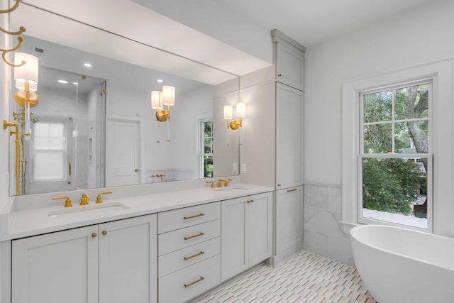 bathroom with vanity, tile walls, tile patterned flooring, and plus walk in shower