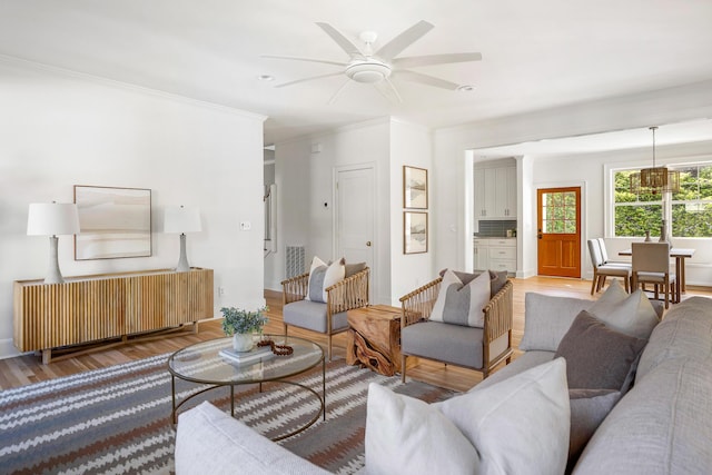 517 Royall Ave, Mount Pleasant, SC 29464 - living area featuring wood finished floors, ceiling fan, crown molding, and radiator heating unit