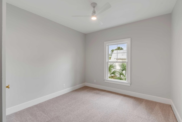 spare room with light carpet and ceiling fan