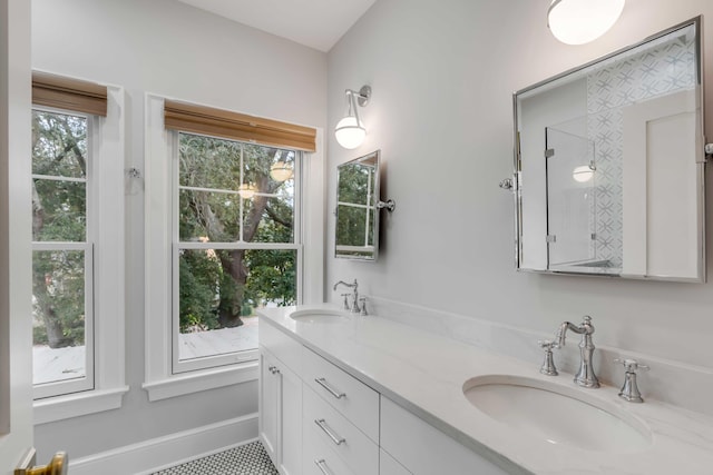 bathroom with vanity, a healthy amount of sunlight, and tile patterned floors