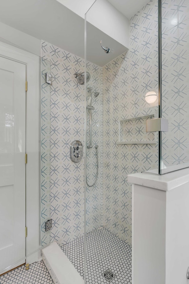 bathroom featuring a shower with door and tile patterned floors