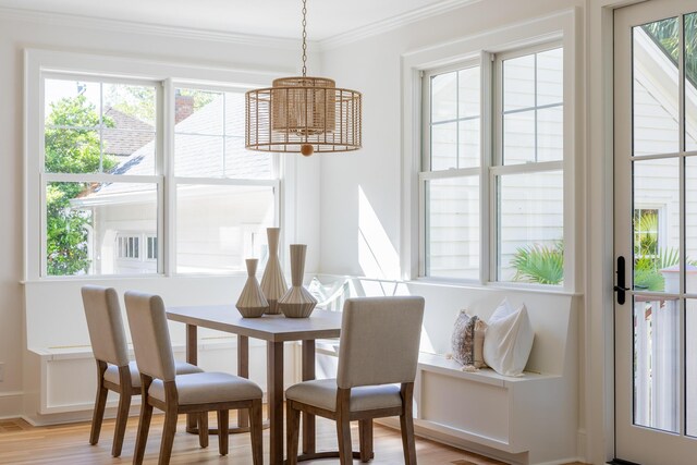 517 Royall Ave, Mount Pleasant, SC 29464 - dining space with plenty of natural light, crown molding, wood finished floors, and a chandelier