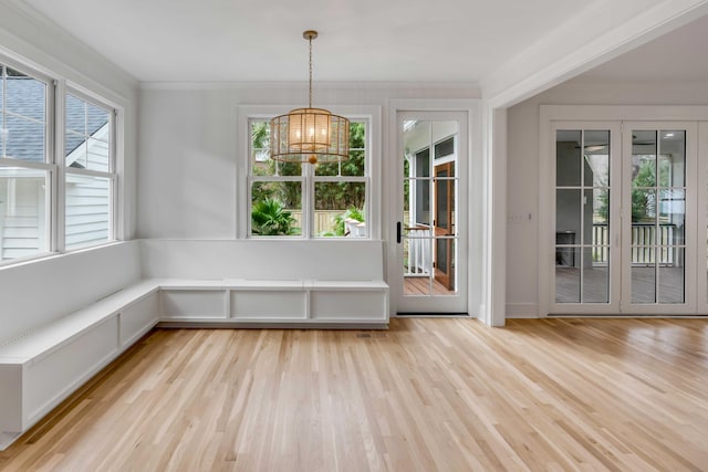 unfurnished sunroom featuring an inviting chandelier and a healthy amount of sunlight