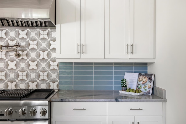 517 Royall Ave, Mount Pleasant, SC 29464 - kitchen with wall chimney exhaust hood, stove, decorative backsplash, and white cabinets