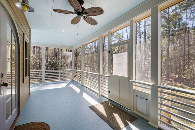 unfurnished sunroom with a ceiling fan