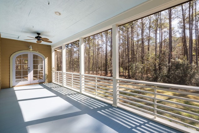 unfurnished sunroom with a ceiling fan