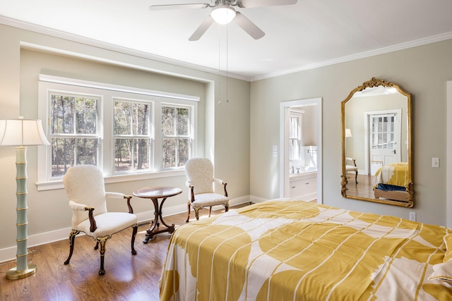 bedroom featuring ensuite bath, crown molding, baseboards, and wood finished floors