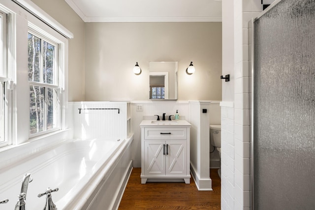 bathroom with crown molding, plenty of natural light, wood finished floors, and a wainscoted wall