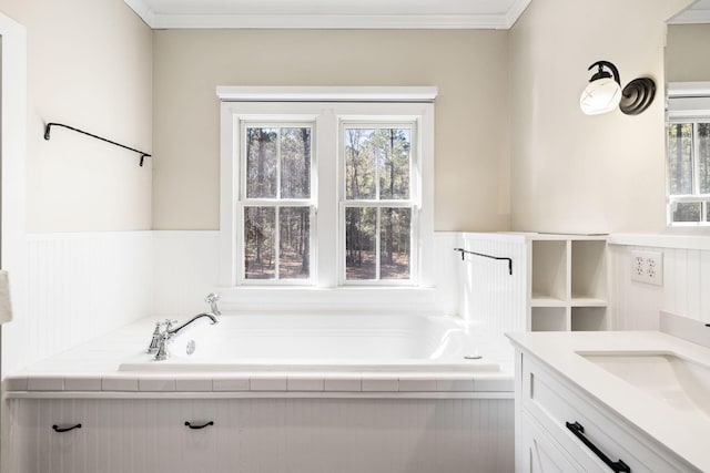 bathroom featuring a wealth of natural light, a wainscoted wall, vanity, and crown molding