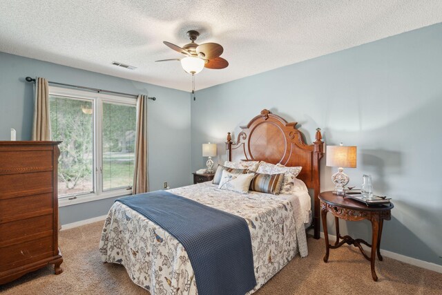 bedroom with carpet flooring, baseboards, ceiling fan, and a textured ceiling