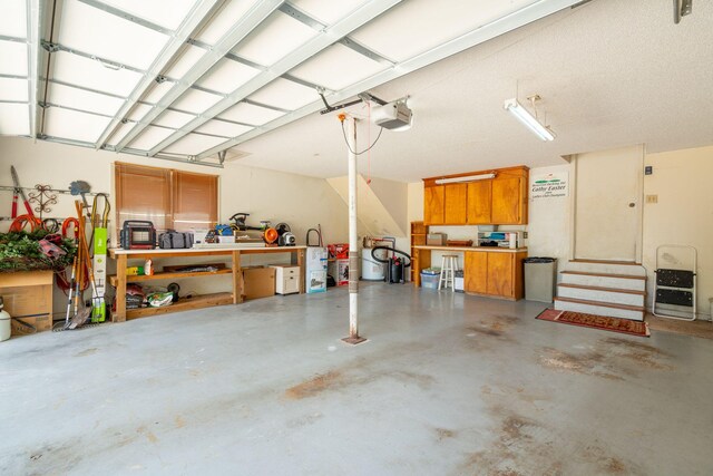 garage with a workshop area and a garage door opener