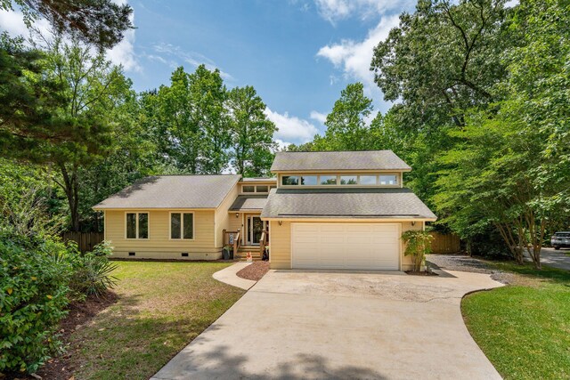 mid-century modern home featuring crawl space, driveway, and a garage