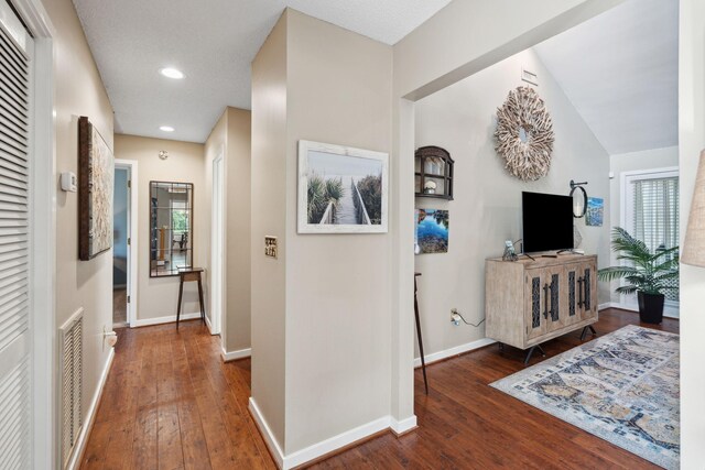 hallway with hardwood / wood-style flooring, baseboards, and recessed lighting