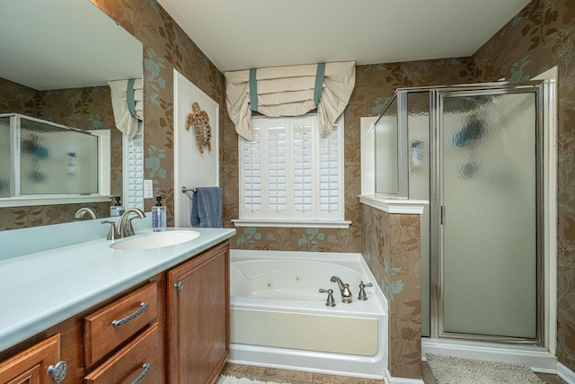 bathroom featuring vanity and independent shower and bath