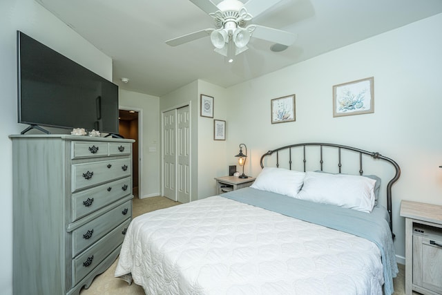 bedroom featuring ceiling fan, light carpet, and a closet