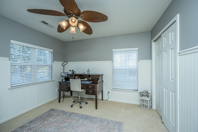 carpeted office featuring ceiling fan and plenty of natural light