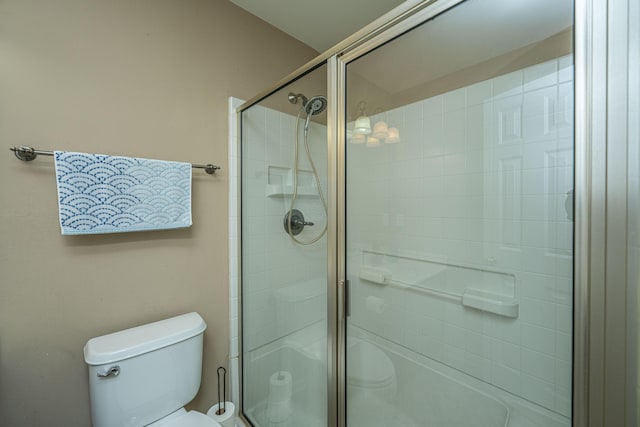 bathroom featuring toilet and walk in shower