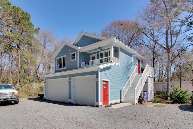 1543 Scott Hill Rd, James Island, SC 29412 - view of front of home with a balcony, a garage, stairway, ceiling fan, and gravel driveway
