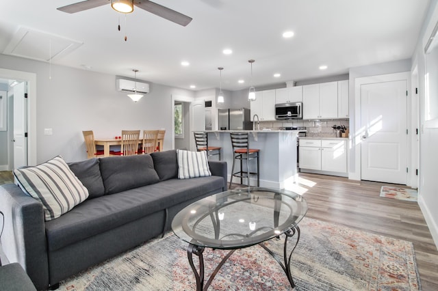 1543 Scott Hill Rd, James Island, SC 29412 - living room with attic access, a ceiling fan, light wood finished floors, a wall mounted air conditioner, and recessed lighting