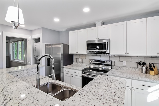 1543 Scott Hill Rd, James Island, SC 29412 - kitchen featuring stainless steel appliances, a sink, white cabinets, light stone counters, and backsplash
