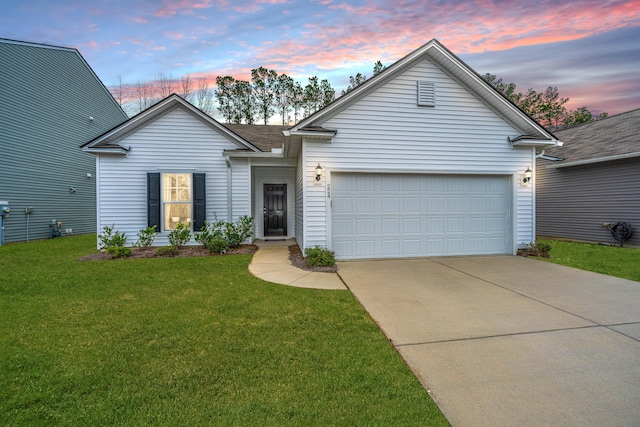 view of front of property featuring a yard and a garage