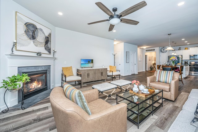 living room with hardwood / wood-style floors and ceiling fan