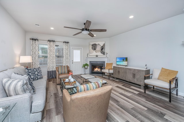 living room with hardwood / wood-style floors and ceiling fan