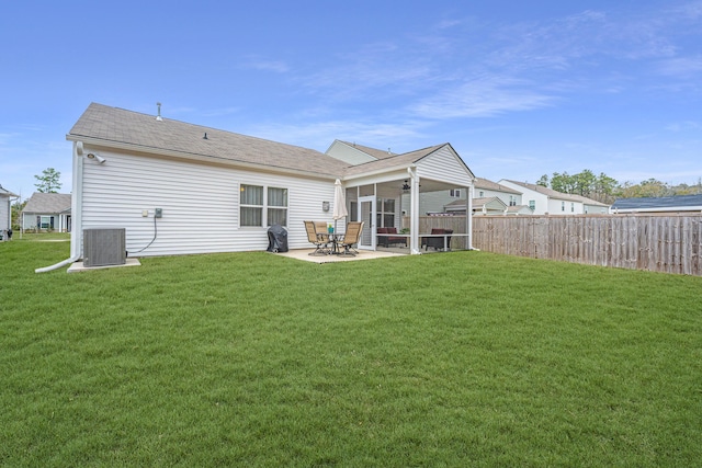 back of property featuring a patio area, a yard, and cooling unit