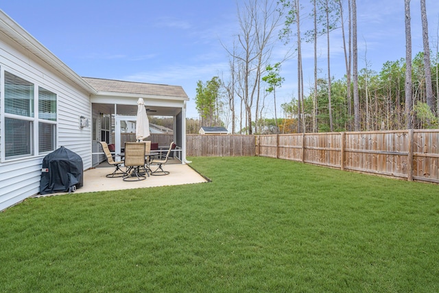 view of yard with ceiling fan and a patio area