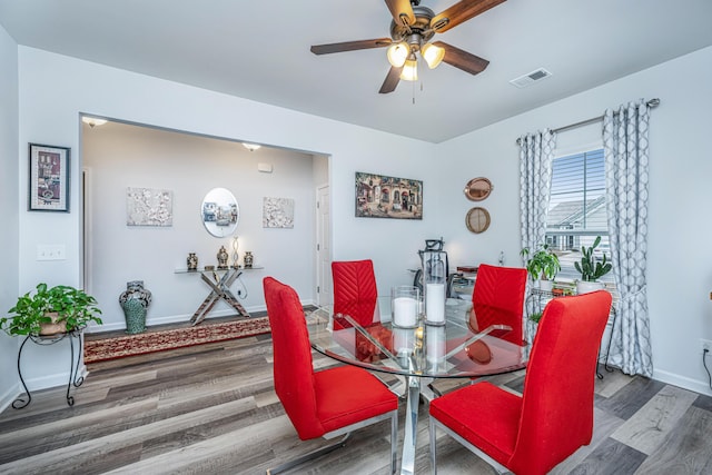 dining room with ceiling fan and hardwood / wood-style floors