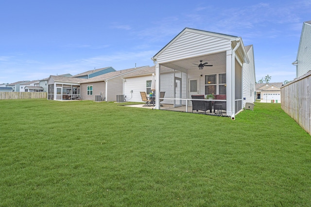 back of property featuring central AC, ceiling fan, a yard, and a patio