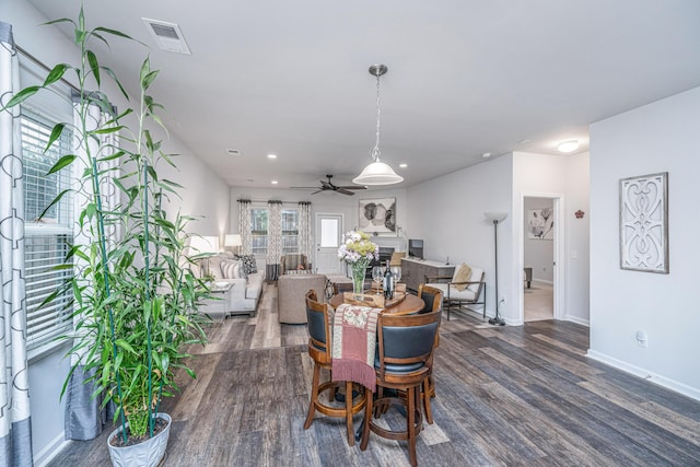 dining space with dark hardwood / wood-style flooring and ceiling fan