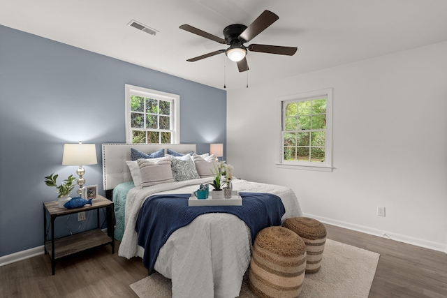 bedroom featuring wood finished floors, baseboards, and a ceiling fan