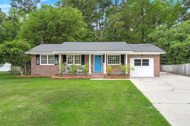 ranch-style home featuring covered porch, driveway, brick siding, and a garage