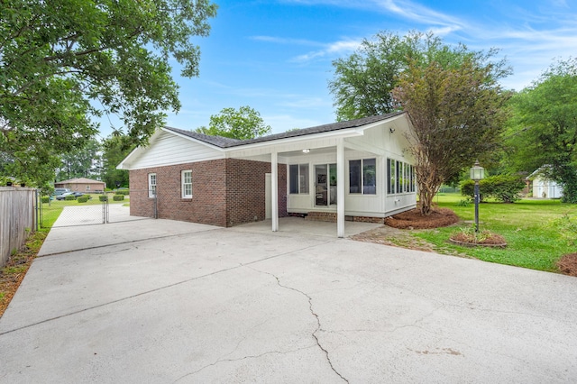 view of home's exterior featuring driveway and a sunroom