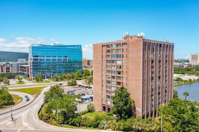 view of property with a water view and a view of city