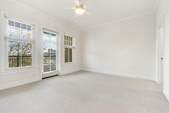 empty room featuring light colored carpet, baseboards, and ornamental molding