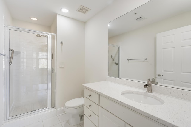 bathroom featuring vanity, a shower stall, toilet, and visible vents